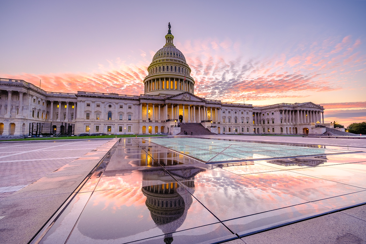A summer sunset brings pink and purple skies to the Capitol, while the dome of the Capitol is reflected in the skylight of the Capitol Visitor Center after a recent rainstorm.
