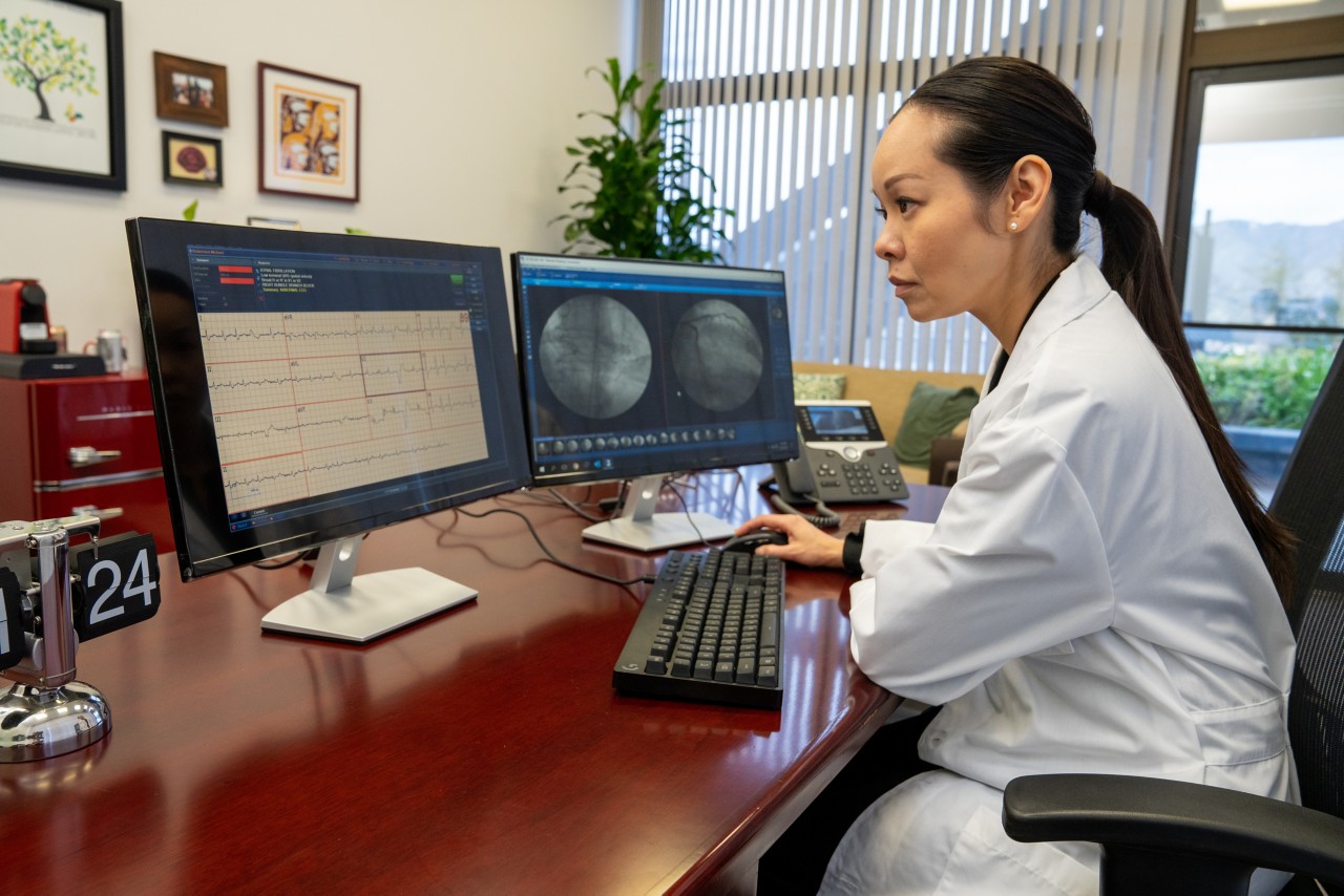 Cardiologist analyzing information on monitor