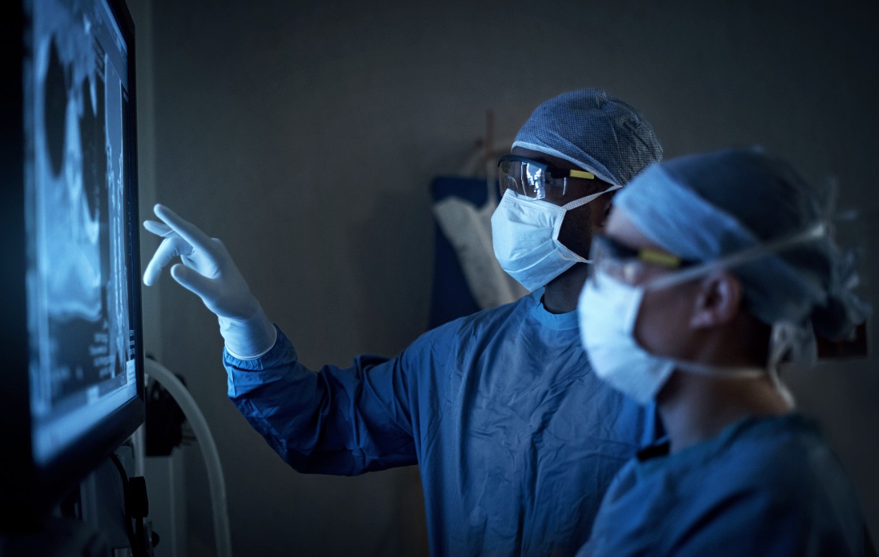 Surgeons reviewing xray on screen