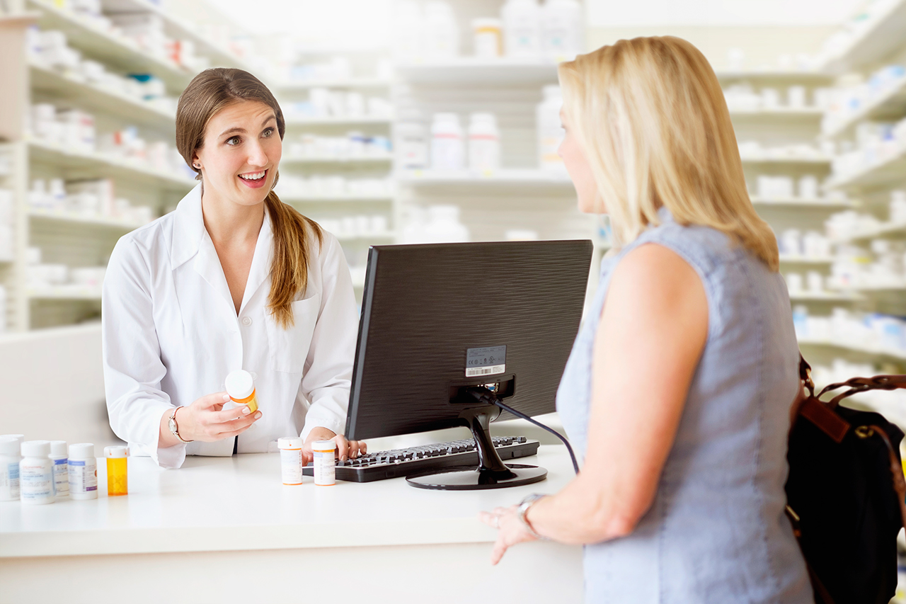 Patient talking to pharmacist in pharmacy