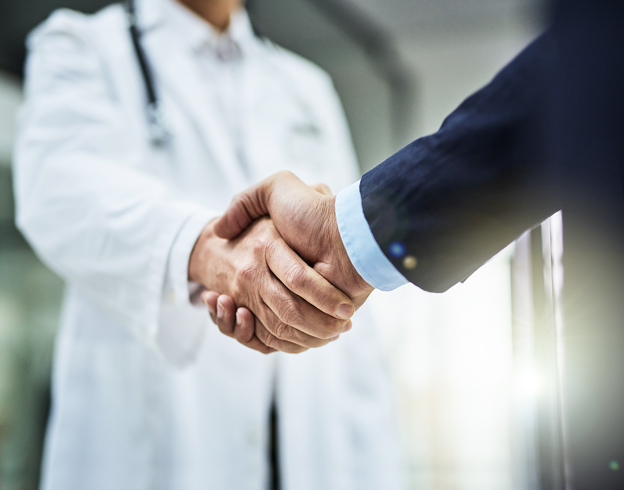 Doctor shaking hands with a businessman